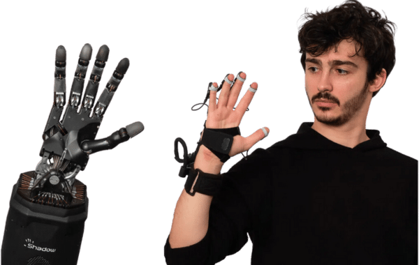 Man wearing shadow glove with the dexterous robot hand waving